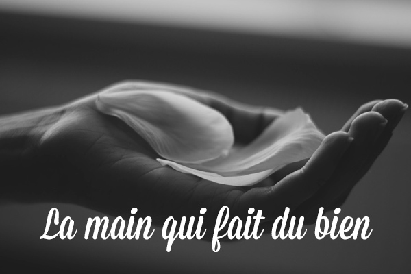 La main qui fait du bien - pétales blancs délicats posés dans une main ouverte